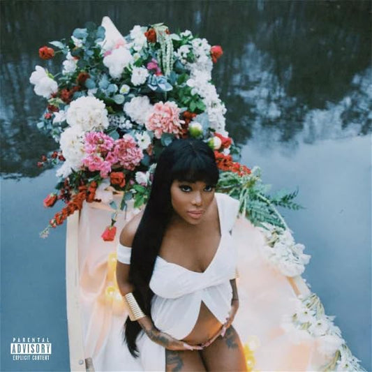 Pregnant woman in a boat surrounded by abundant white and red flowers.