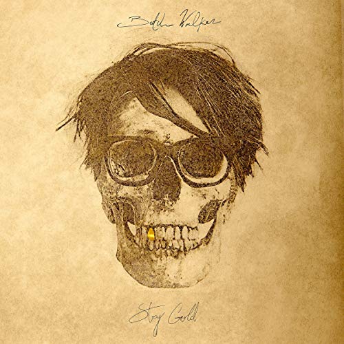 A sketch of a skull wearing glasses and a gold tooth on parchment paper.
