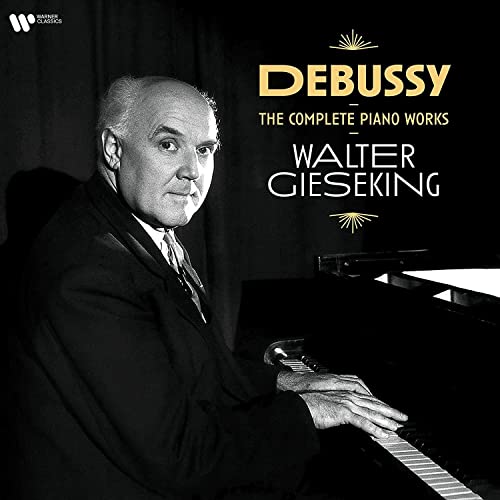 Black and white portrait of pianist Walter Gieseking at a piano.