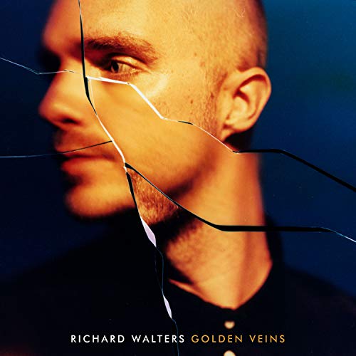 Man's face is visible through a shattered glass effect on album cover.
