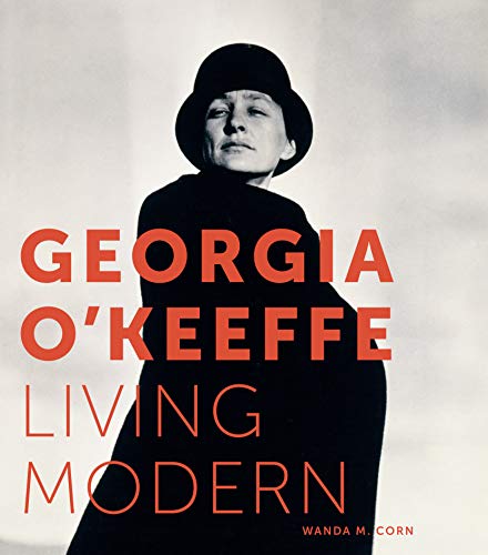 Black and white portrait of Georgia O'Keeffe wearing a hat with red text overlay.