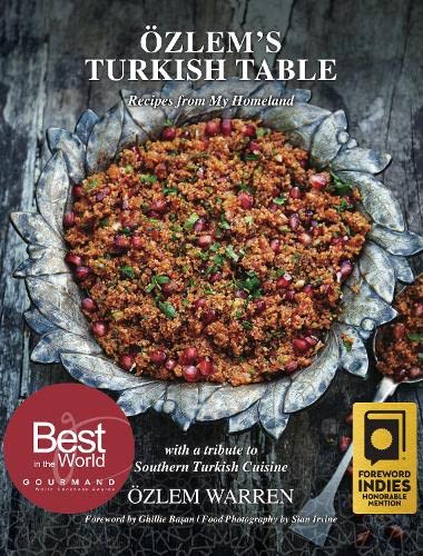 Cookbook cover featuring a dish with pomegranate seeds in a decorative metal bowl.