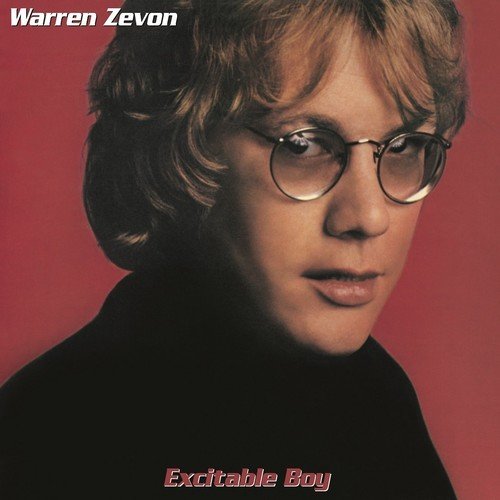 Warren Zevon's album cover featuring a man with glasses against a red background.