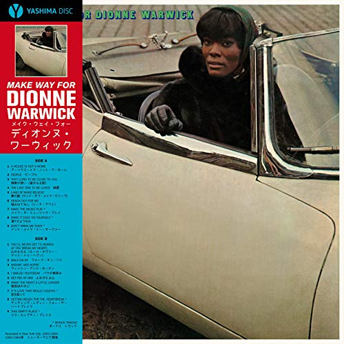Dionne Warwick sits in a white convertible on this vinyl album cover.