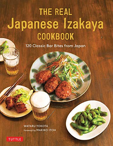 Cookbook cover with Japanese food, beer, and chopsticks on a wood table.