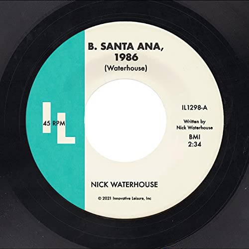 Vinyl record label with turquoise band, text, and center hole.