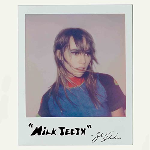 Polaroid-style photo of Suki Waterhouse with Milk Teeth written in black marker below.