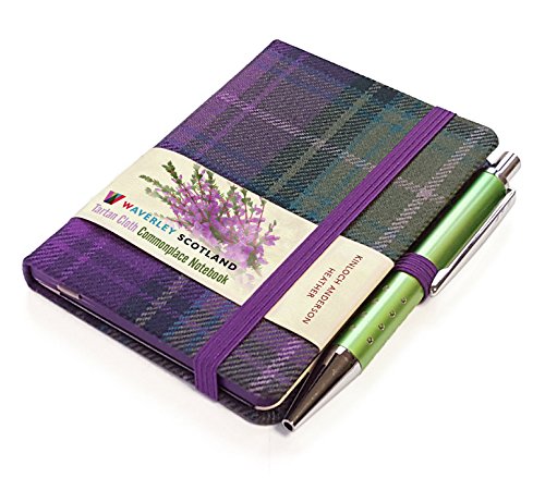 Small purple tartan notebook with a green pen and a heather flower paper band.