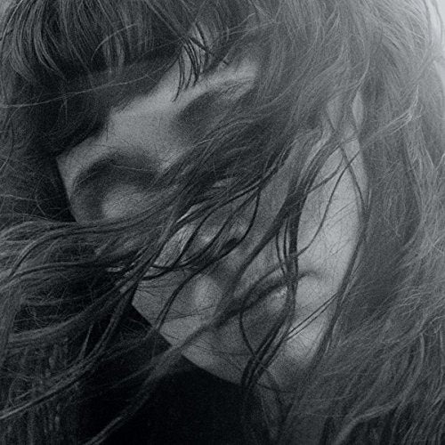 Black and white portrait of a woman with flowing hair.