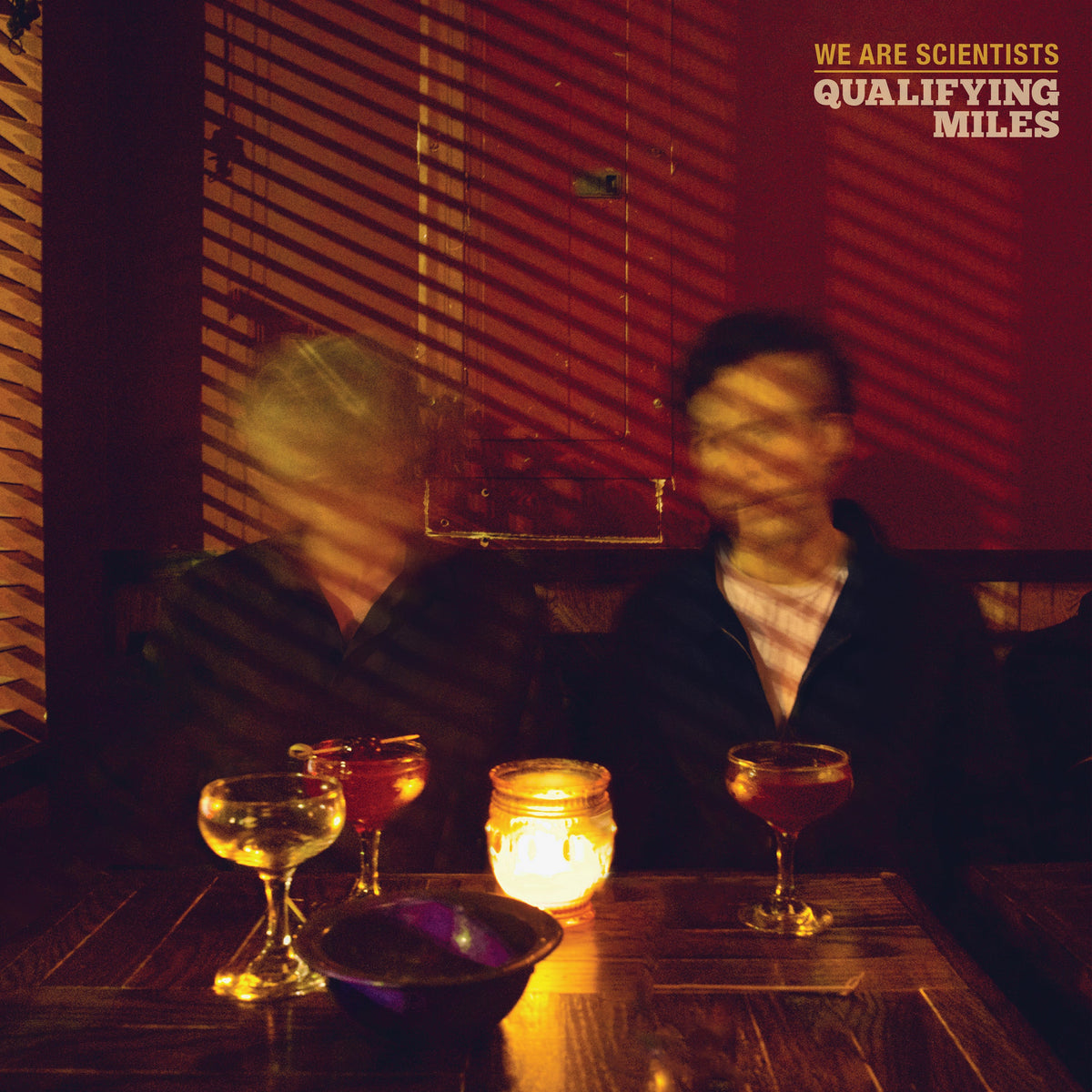 Album cover for “Qualifying Miles” by We Are Scientists, blurred figures.