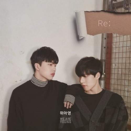 Two young men in dark clothing pose against a wall with a torn paper overlay.