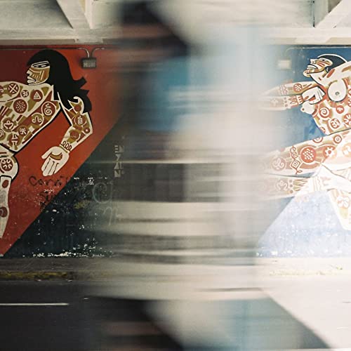 CD cover with blurred figure and colorful mural artwork.