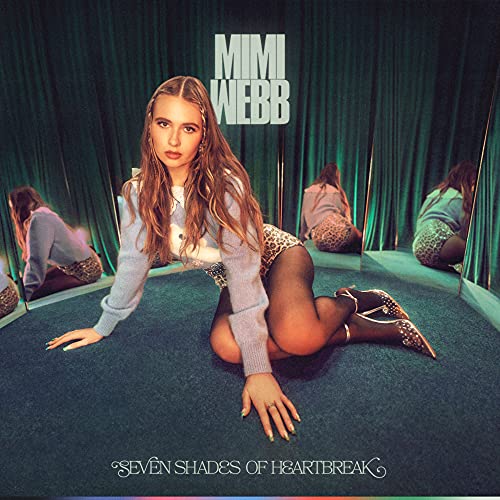 Mimi Webb album cover featuring the artist seated amidst mirrored reflections.