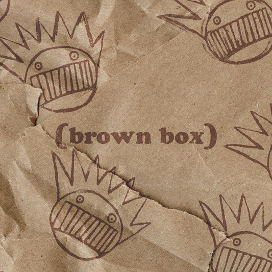 Brown cardboard with repeated cartoon faces and the text “brown box”.