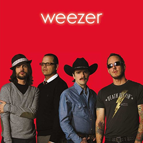 Weezer band members in hats and varied attire against a red background.