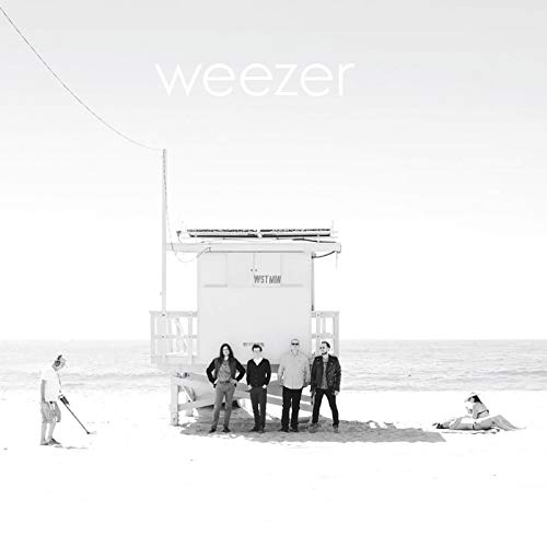 Black and white album cover of Weezer standing on a beach.