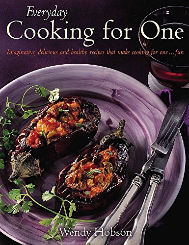 Cookbook cover with stuffed eggplant, parsley, silverware, and wine.