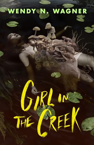Woman partially submerged in water, covered in mushrooms and foliage.