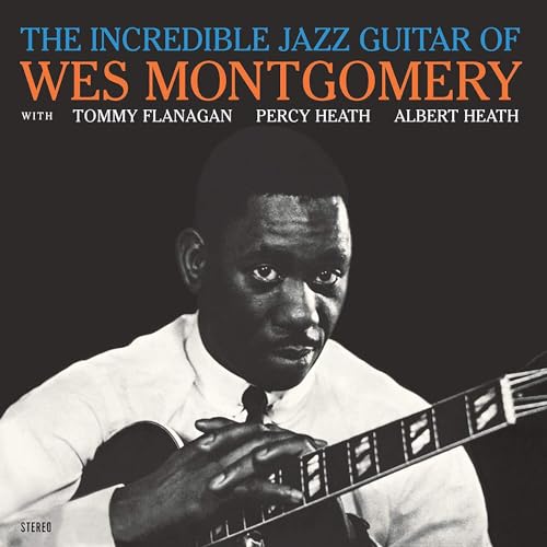 Black and white portrait of jazz guitarist Wes Montgomery with his guitar.