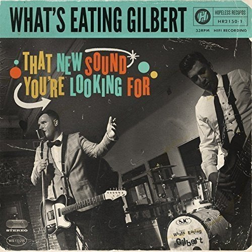 "Black and white photo of two men playing guitars on a vinyl record cover."