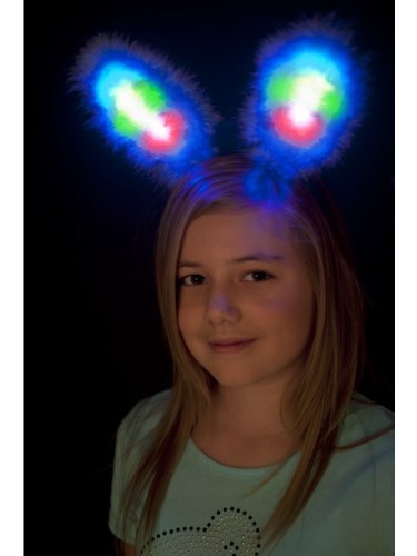Woman wearing white, fluffy bunny ears with bright blue and multi-colored lights.