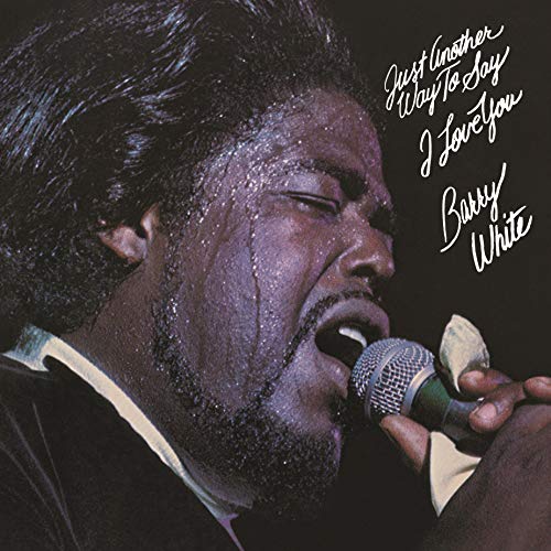 Barry White singing into a microphone on album cover.