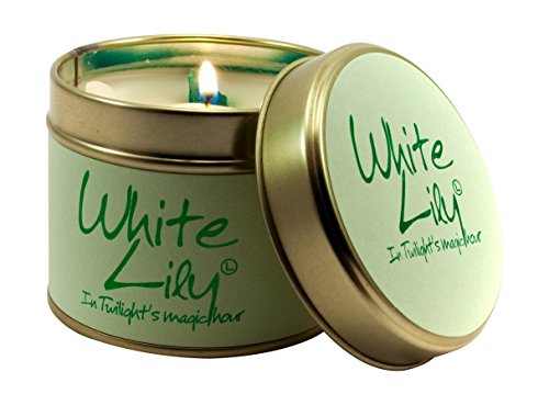 Green tin candle with white "White Lily" text and a lit wick.