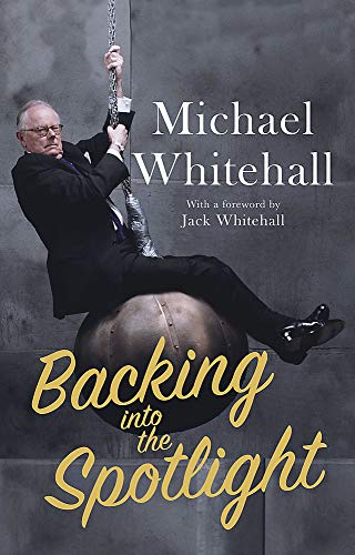 Book cover featuring Michael Whitehall suspended from a chain, seated on a ball.