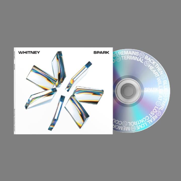 Whitney’s “SPARK” CD with abstract iridescent crystal shard design.
