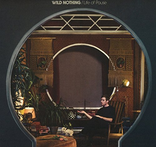 Album cover: man in a room viewed through arched openings.