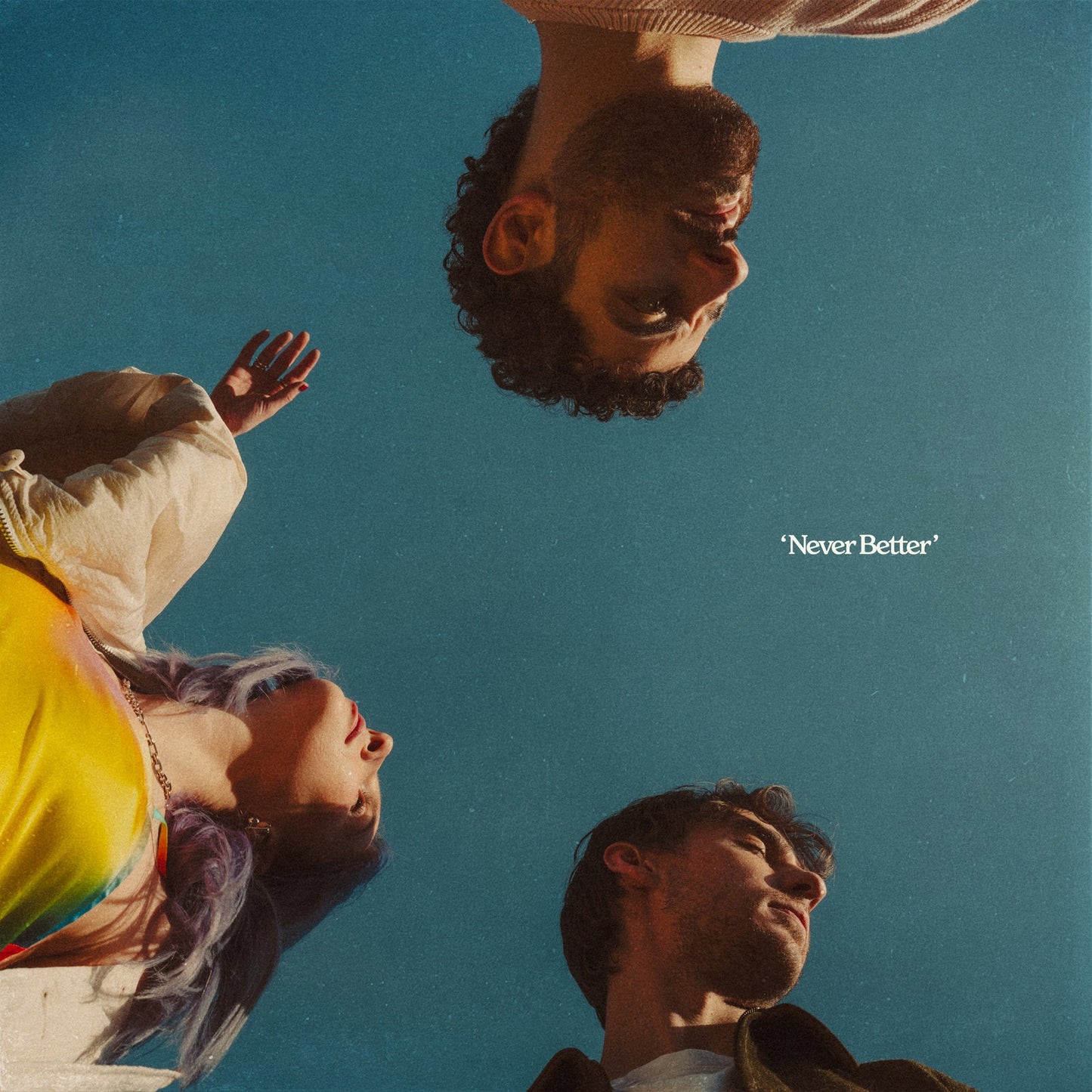 Album cover for Wild Rivers’ “Never Better” featuring three faces against blue.