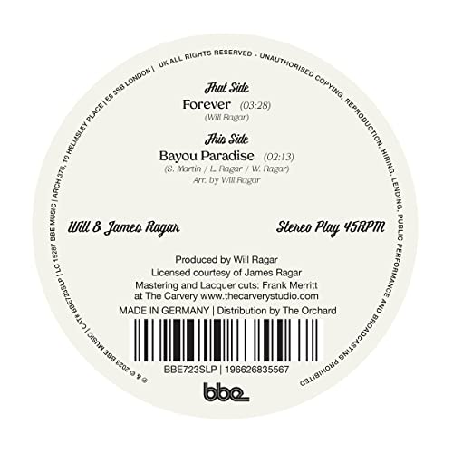 Close-up of a white and black 7-inch vinyl record label with song titles.