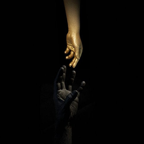 Golden hand reaching for a dark, shadowy hand against black.