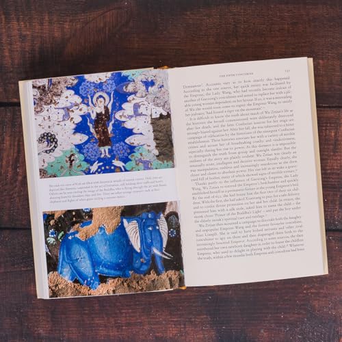 Open book displaying colorful ancient Indian art and dense text.