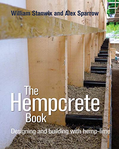 Book cover showing a timber frame wall being filled with hempcrete insulation material.