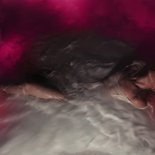 Person submerged in swirling pink and white water, album cover.
