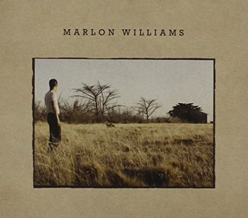 CD cover: man standing in a field, looking towards distant trees.