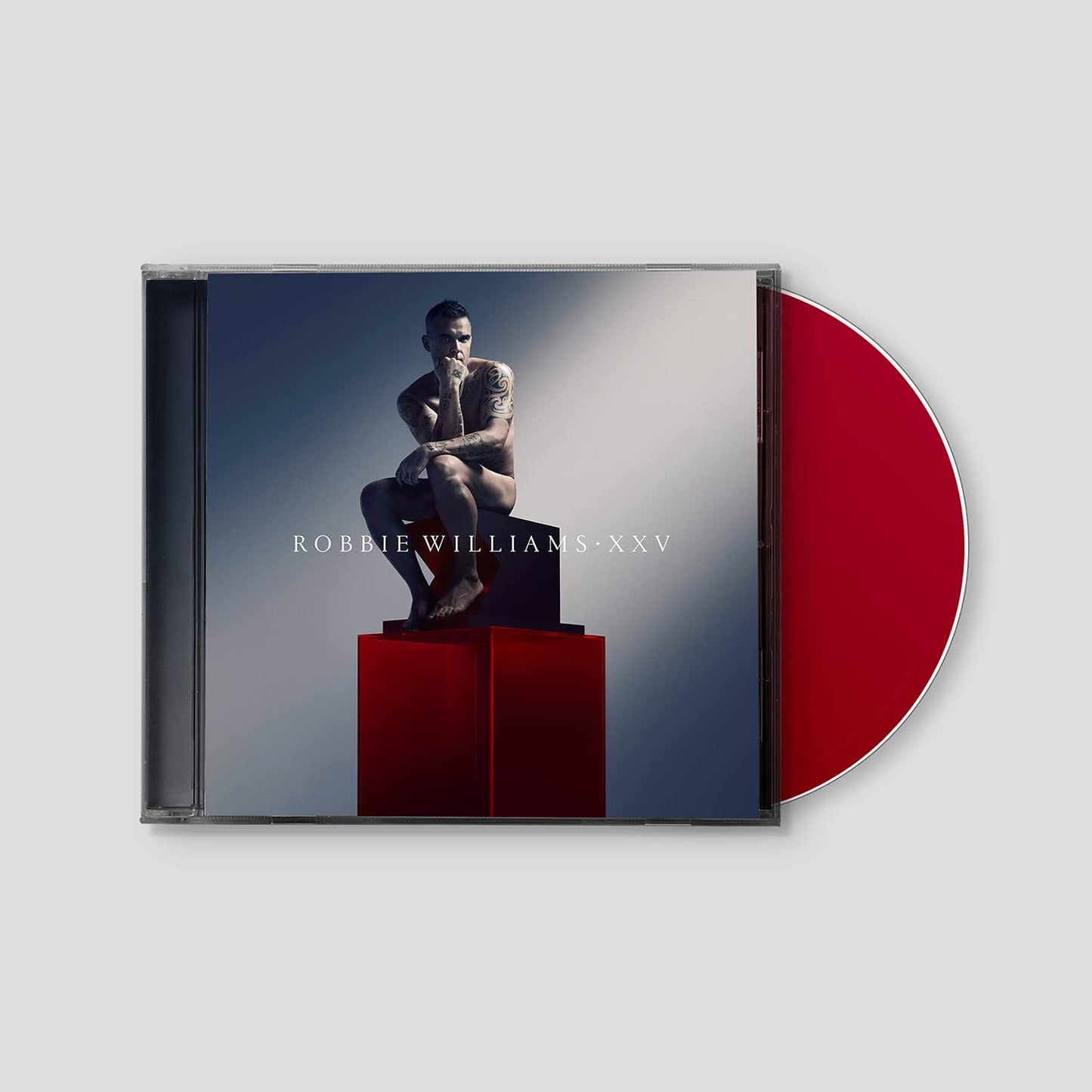 Robbie Williams XXV CD case with a red disc partially visible.