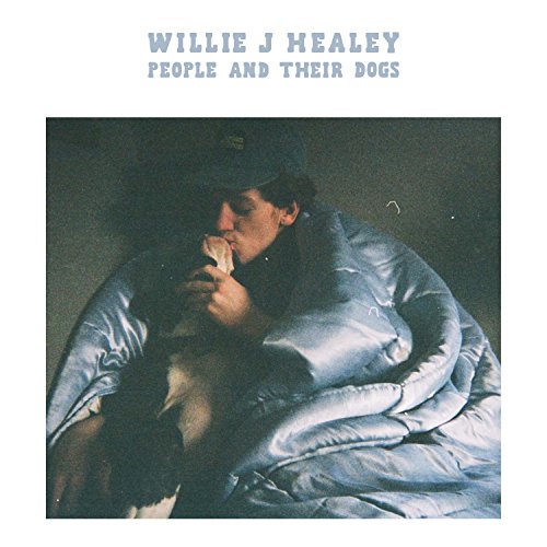 "Album cover with a man in bed, eating, and a dog beside him."