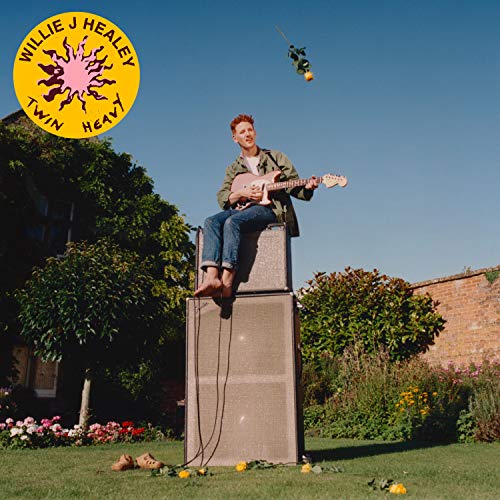 Album cover: Willie J Healey playing guitar atop large speakers outdoors.
