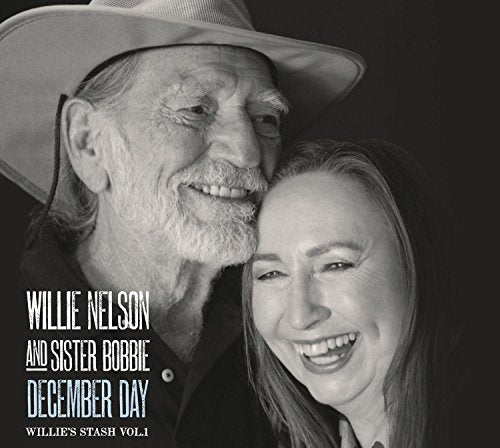 Black and white portrait of Willie Nelson and Sister Bobbie smiling.