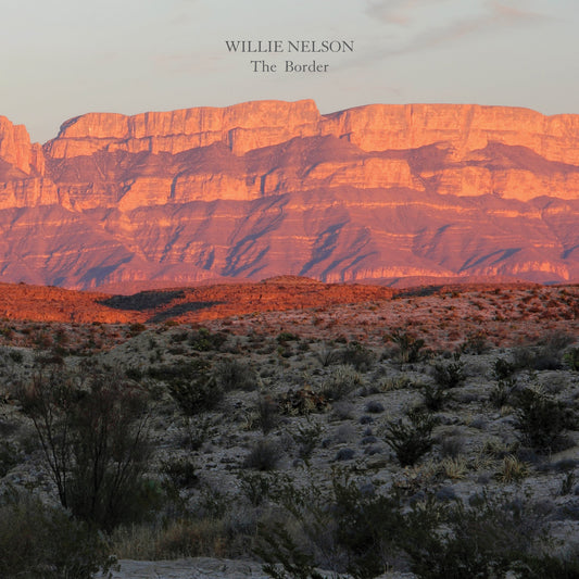 Album cover for Willie Nelson’s “The Border” featuring a desert landscape.