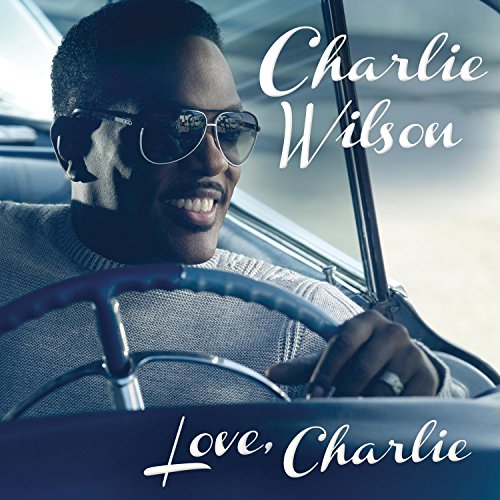 Charlie Wilson smiles wearing sunglasses, driving a classic car; album cover.