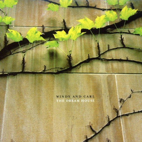 "CD cover with vine on a wooden surface, 'Windy and Carl - The Dream House' text."