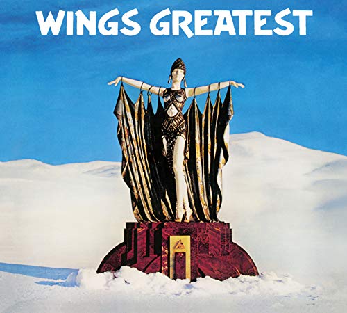 Wings Greatest album cover featuring a statue in a snowy landscape under blue sky.