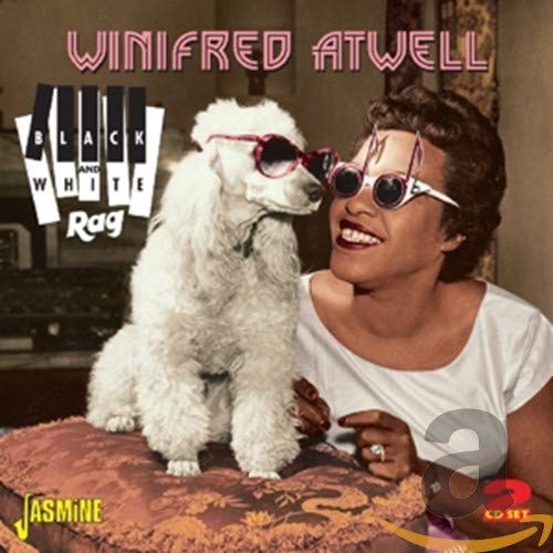 Winifred Atwell smiling with a poodle, both wearing novelty glasses, on a CD cover.