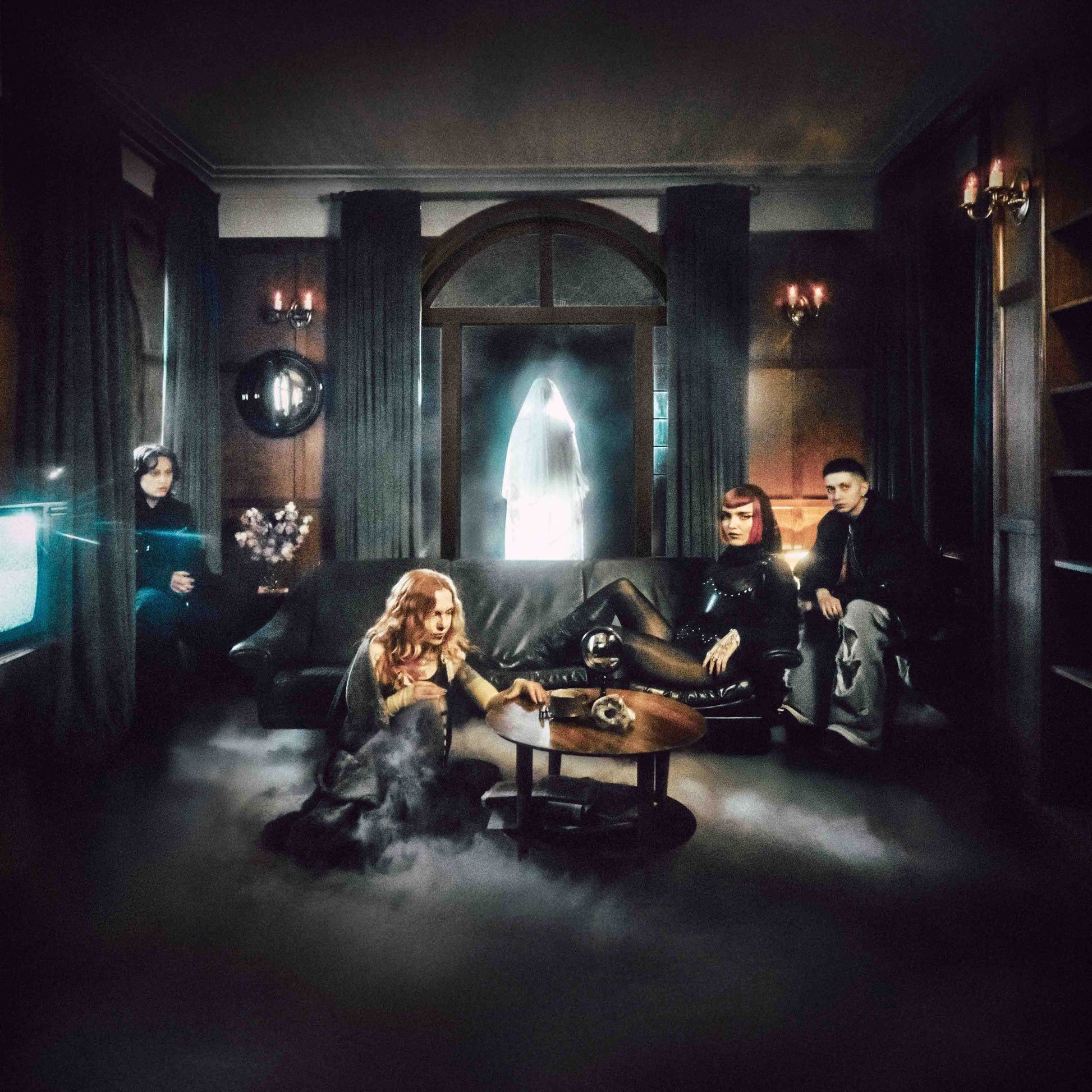 Band in a darkly lit, ornate room filled with smoke and figures.