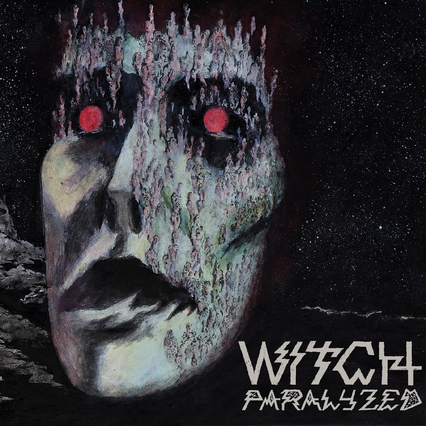 Painted face with red eyes and textured details against a dark background.