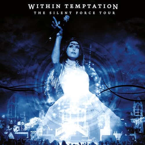 Singer Sharon den Adel performing on stage in a bright blue concert lighting effect.