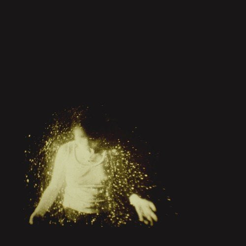 A person surrounded by yellow sparks against a black background.